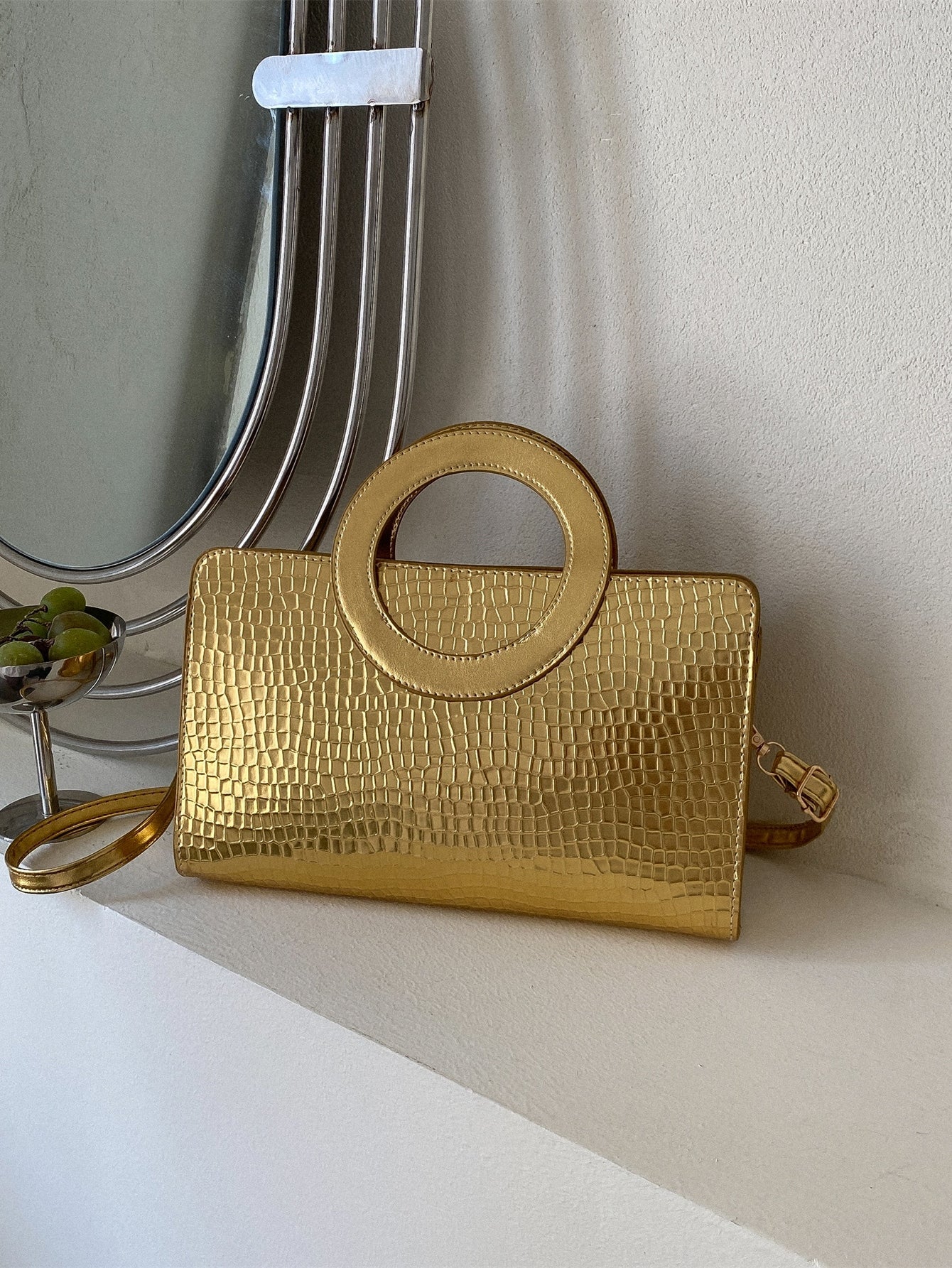 Square bag with metallic crocodile embossing, ring on top